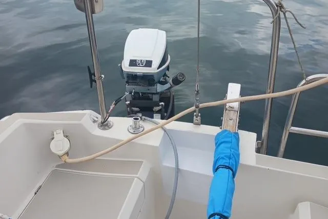 Slide: The Image of 1989 O'Day 272 sailboat with outboard motor on calm water. - 5