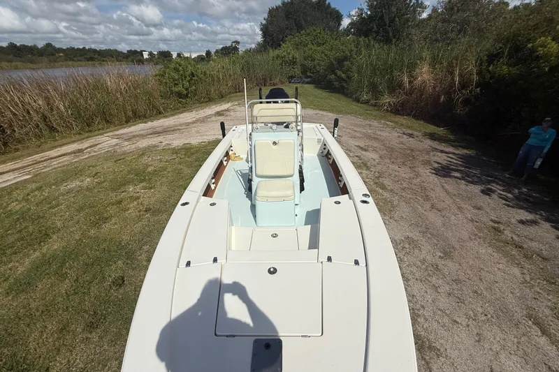 Slide: The Image of 2016 Pathfinder 2300 HPS boat on grassy terrain near water and trees. - 19