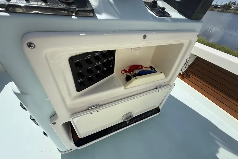 Slide: The Image of 2016 Pathfinder 2300 HPS boat console with control panel and storage compartment. - 27