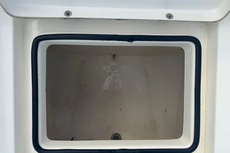 Slide: The Image of Open storage compartment on 2016 Pathfinder 2300 HPS boat, featuring a clean interior. - 31