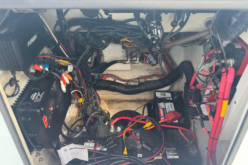 Slide: The Image of 2016 Pathfinder 2300 HPS boat electrical compartment with wiring and batteries. - 37