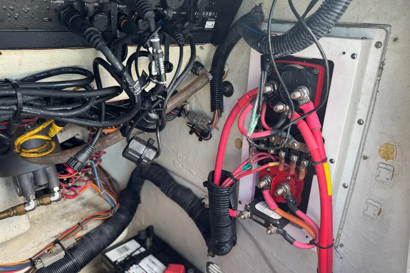 Slide: The Image of Tangled wiring and battery setup in a 2016 Pathfinder 2300 HPS boat. - 39