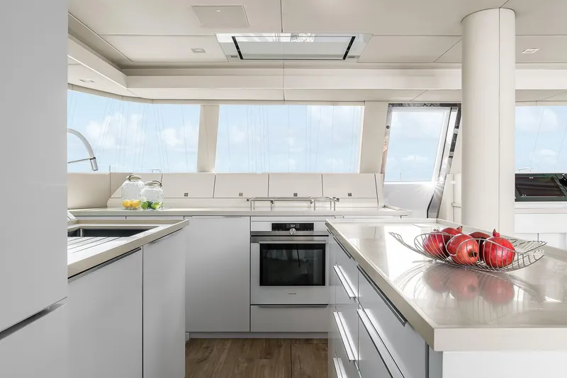Slide: The Image of Luxurious Sunreef 50 yacht kitchen interior with modern appliances and panoramic windows, 2026 model. - 10