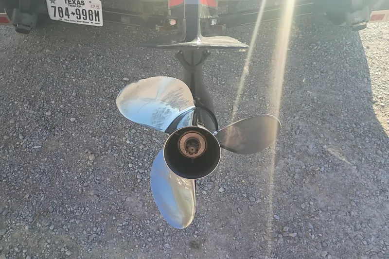 Slide: The Image of Propeller of 2005 Ranger 519SVX Comanche boat on gravel surface, sunlight reflecting. - 4
