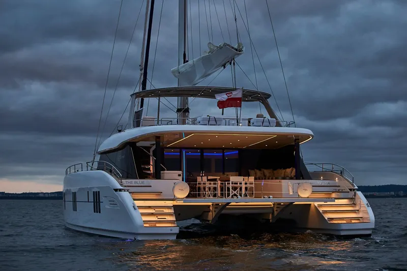 The Image of Luxurious 2026 Sunreef 60 yacht illuminated at dusk on calm waters. - 3