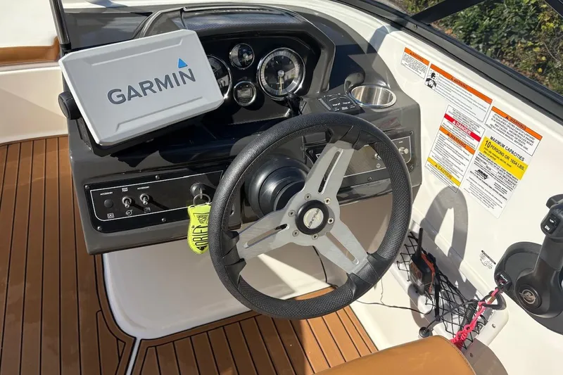 Slide: The Image of 2021 Bayliner VR6 Bowrider OB dashboard with Garmin device and steering wheel. - 10