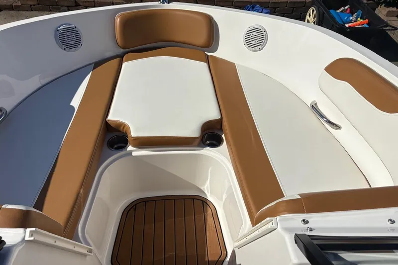 Slide: The Image of 2021 Bayliner VR6 Bowrider OB interior with tan and white seating, wood flooring. - 11