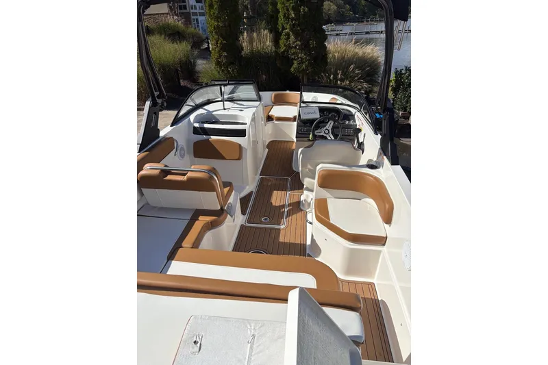 Slide: The Image of 2021 Bayliner VR6 Bowrider OB interior with tan seating and wood flooring. - 12