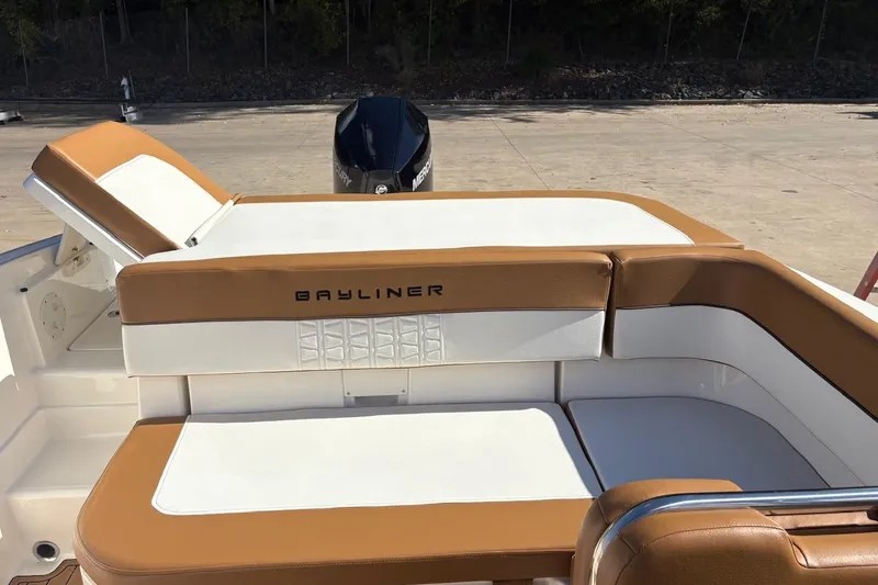 Slide: The Image of 2021 Bayliner VR6 Bowrider OB with tan and white seating, outdoor setting. - 5