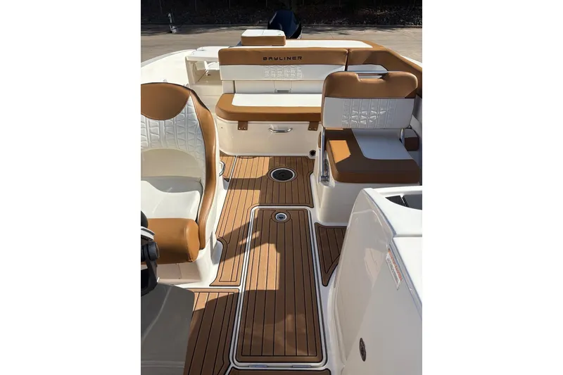 Slide: The Image of 2021 Bayliner VR6 Bowrider OB interior with tan and white seating, wood-style flooring. - 6