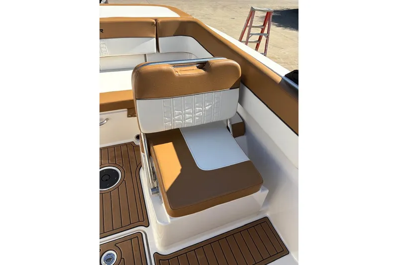 Slide: The Image of 2021 Bayliner VR6 Bowrider OB interior with tan and white seating. - 8