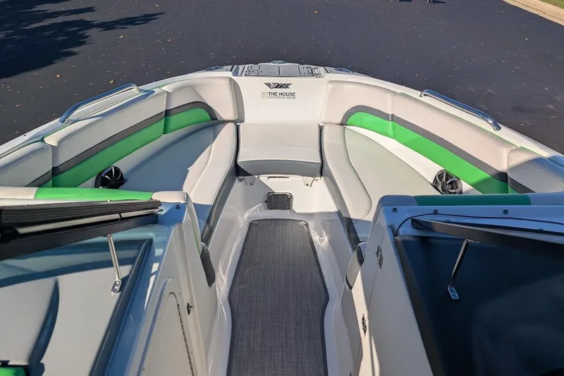 Slide: The Image of 2018 Chaparral Vortex 223 VRX boat interior with green and gray seating. - 11