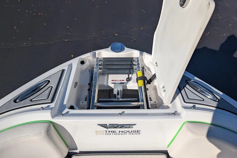 Slide: The Image of 2018 Chaparral Vortex 223 VRX boat with open storage compartment and ladder. - 12