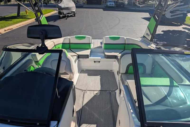 Slide: The Image of 2018 Chaparral Vortex 223 VRX boat interior with green accents and seating. - 14