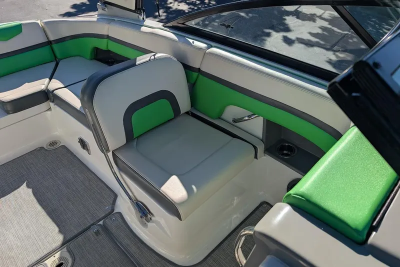 Slide: The Image of 2018 Chaparral Vortex 223 VRX boat interior with green and gray seating. - 15