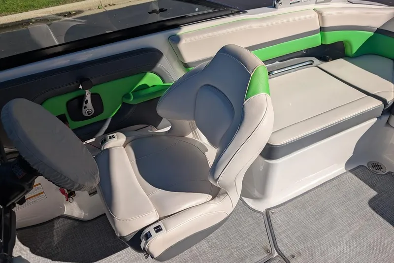 Slide: The Image of 2018 Chaparral Vortex 223 VRX boat interior with green and gray seating. - 16
