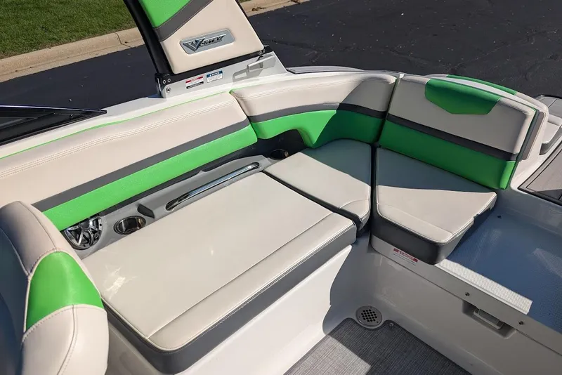 Slide: The Image of 2018 Chaparral Vortex 223 VRX boat interior with green and gray seating. - 17