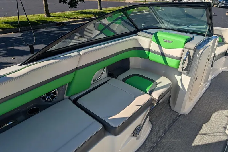 Slide: The Image of 2018 Chaparral Vortex 223 VRX boat interior with green and gray seating. - 19
