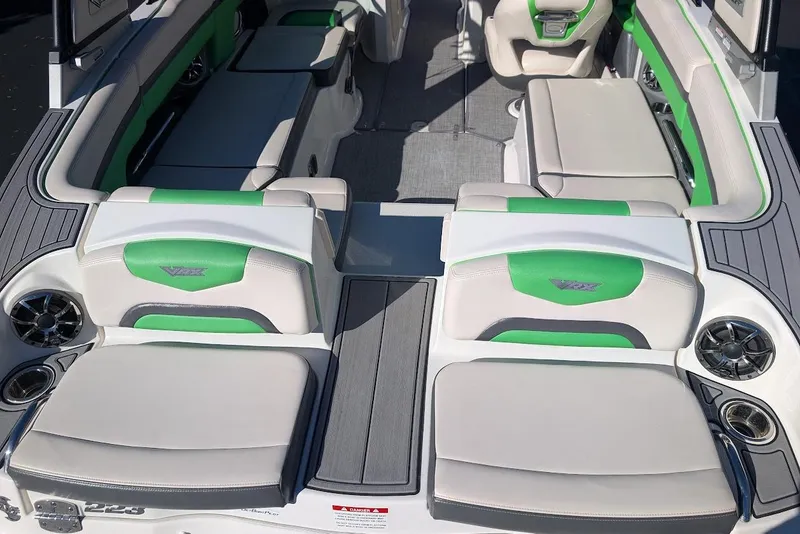 Slide: The Image of 2018 Chaparral Vortex 223 VRX boat interior with green and white seating, modern design. - 25