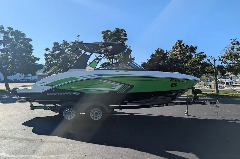 Slide: The Image of 2018 Chaparral Vortex 223 VRX boat on trailer, green and white design, parked outdoors. - 3