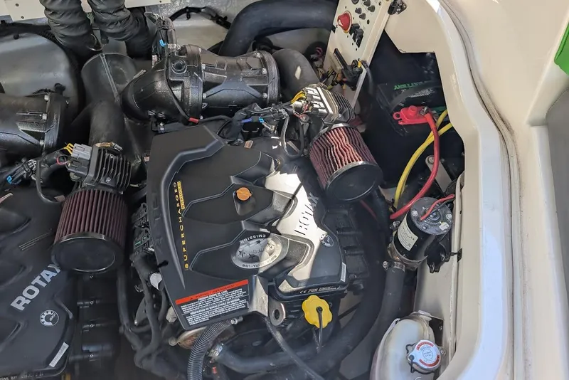 Slide: The Image of Engine compartment of a 2018 Chaparral Vortex 223 VRX boat, showcasing supercharged components. - 30