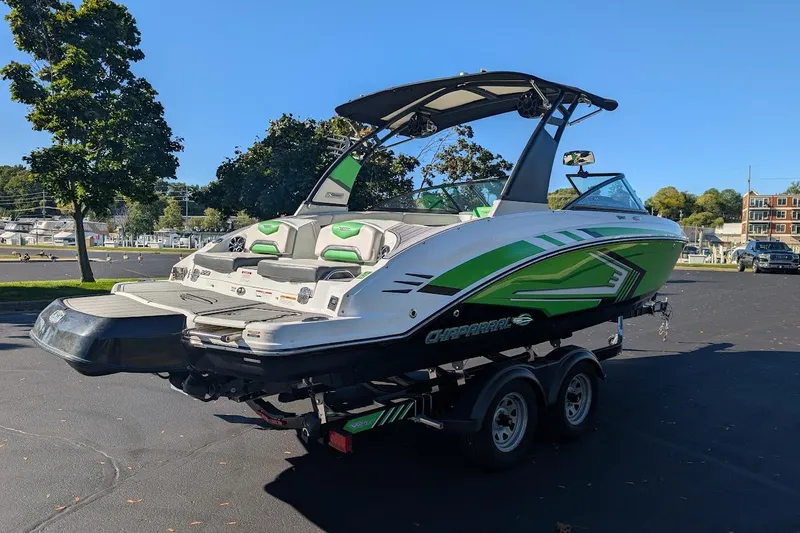 Slide: The Image of 2018 Chaparral Vortex 223 VRX boat on trailer, featuring green and white design. - 4
