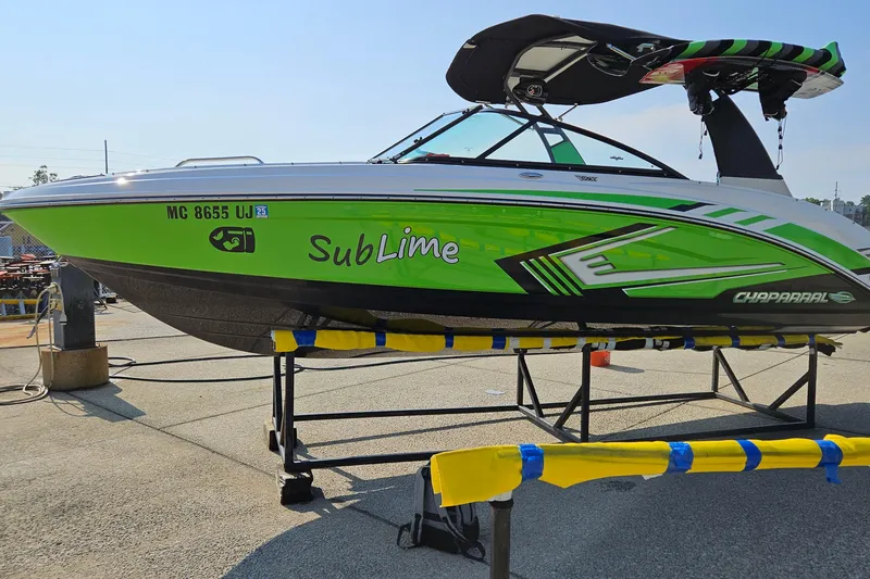 Slide: The Image of 2018 Chaparral Vortex 223 VRX boat with vibrant green design on display. - 7