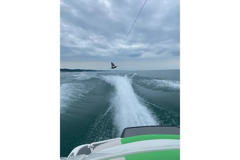 Slide: The Image of 2018 Chaparral Vortex 223 VRX towing a wakeboarder on a cloudy day. - 8