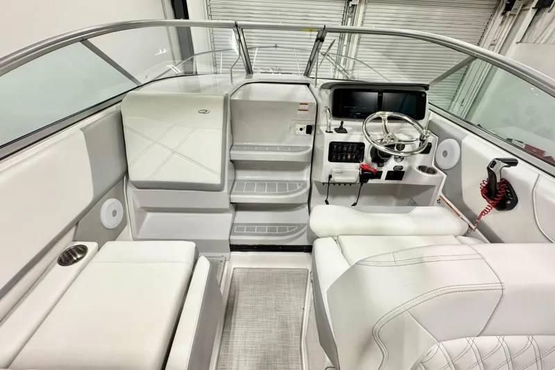 Slide: The Image of 2026 Regal 26 XO boat interior with modern helm, seating, and controls. - 11