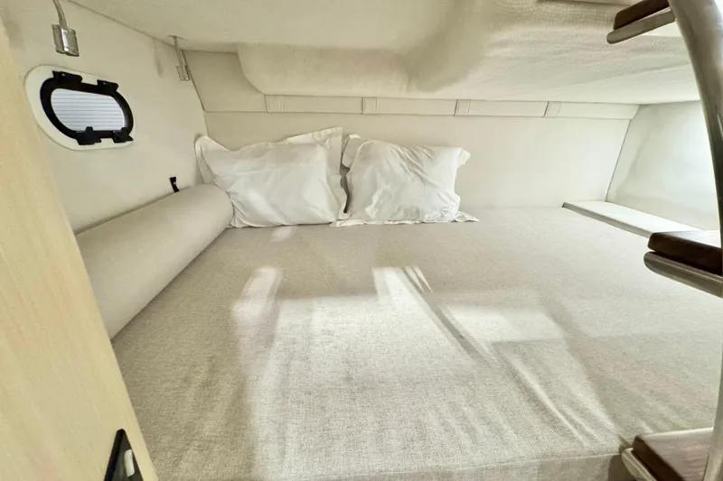 Slide: The Image of Cozy cabin interior of 2026 Regal 26 XO boat with comfortable bedding. - 13
