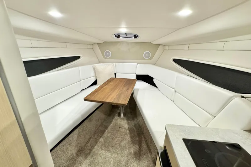 Slide: The Image of Luxurious interior of 2026 Regal 26 XO boat with white seating and wooden table. - 14