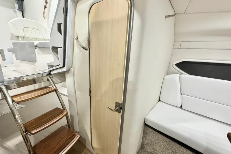 Slide: The Image of 2026 Regal 26 XO interior with wooden steps, door, and white seating. - 15