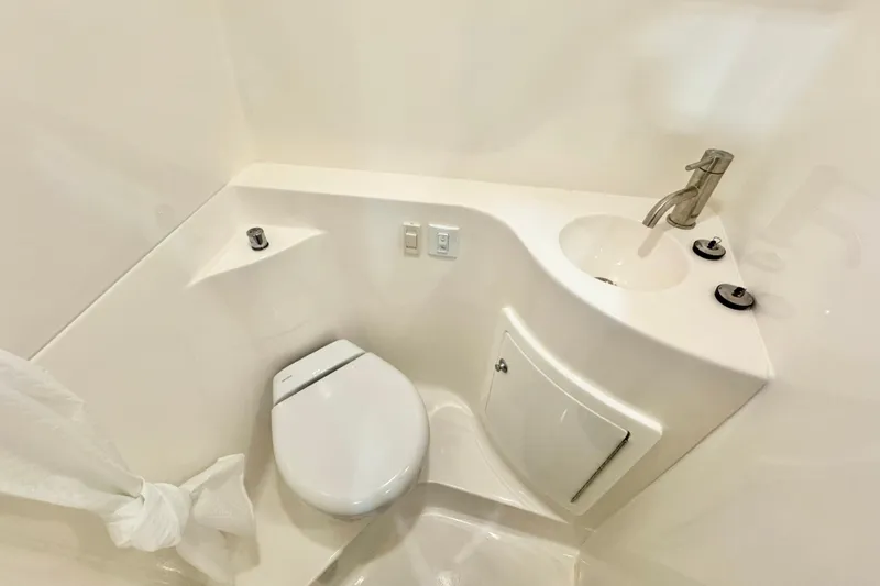 Slide: The Image of Compact bathroom in 2026 Regal 26 XO boat with modern fixtures and sleek design. - 16