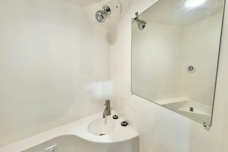 Slide: The Image of Compact bathroom in 2026 Regal 26 XO boat with sink, mirror, and showerhead. - 17