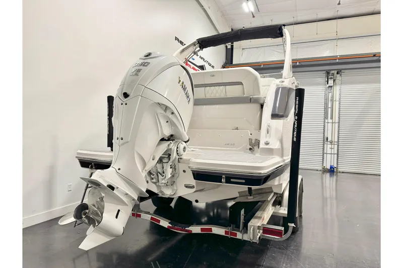Slide: The Image of 2026 Regal 26 XO boat with Yamaha outboard motor in a showroom. - 3