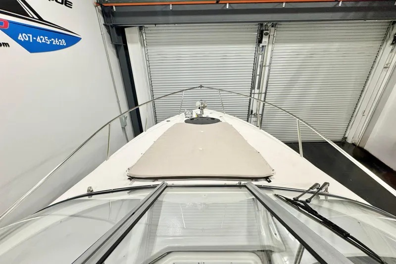 Slide: The Image of 2026 Regal 26 XO boat in storage, viewed from the bow, with closed garage doors. - 4