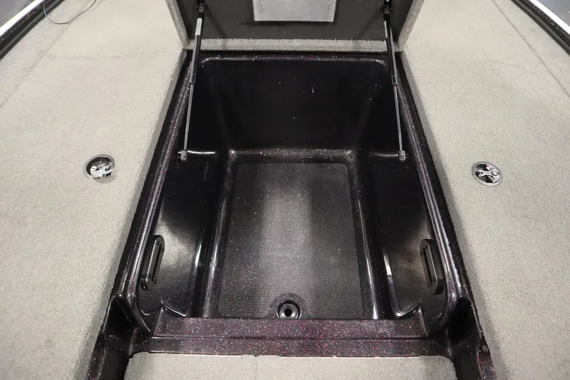 Slide: The Image of Open storage compartment in 2014 Nitro Z-7 boat, featuring carpeted interior and hydraulic lift. - 21
