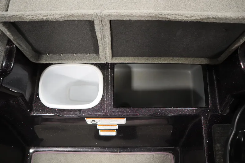 Slide: The Image of 2014 Nitro Z-7 boat storage compartments with carpeted lids and warning labels. - 23