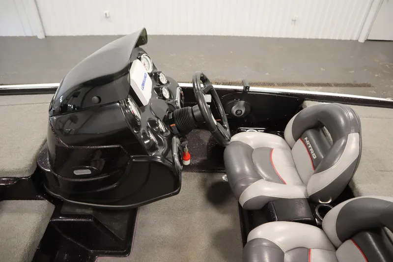 Slide: The Image of 2014 Nitro Z-7 boat interior with steering console and cushioned seats. - 24