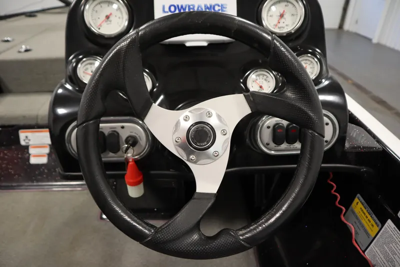 Slide: The Image of Steering wheel and dashboard of 2014 Nitro Z-7 boat with gauges and controls. - 26