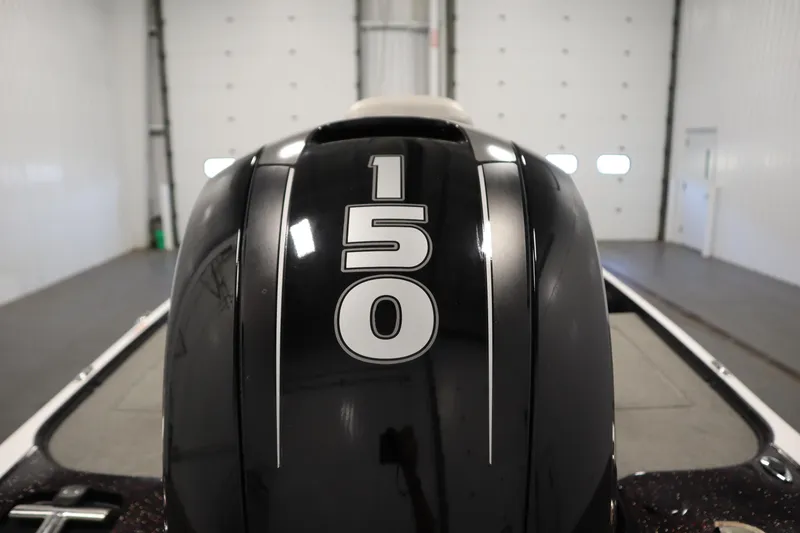 Slide: The Image of 2014 Nitro Z-7 boat engine with "150" horsepower label in a garage setting. - 44