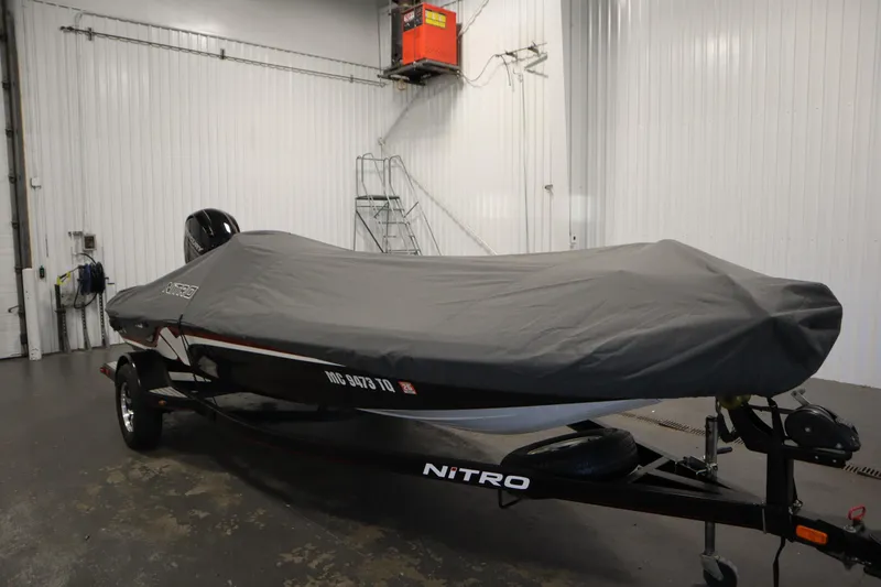 Slide: The Image of 2014 Nitro Z-7 boat covered in a garage, showcasing sleek design and protective cover. - 50