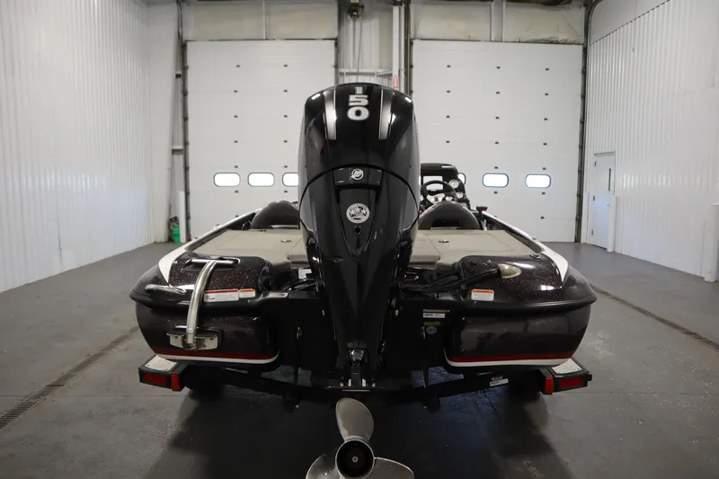 Slide: The Image of 2014 Nitro Z-7 boat in a garage, rear view with powerful outboard motor. - 6