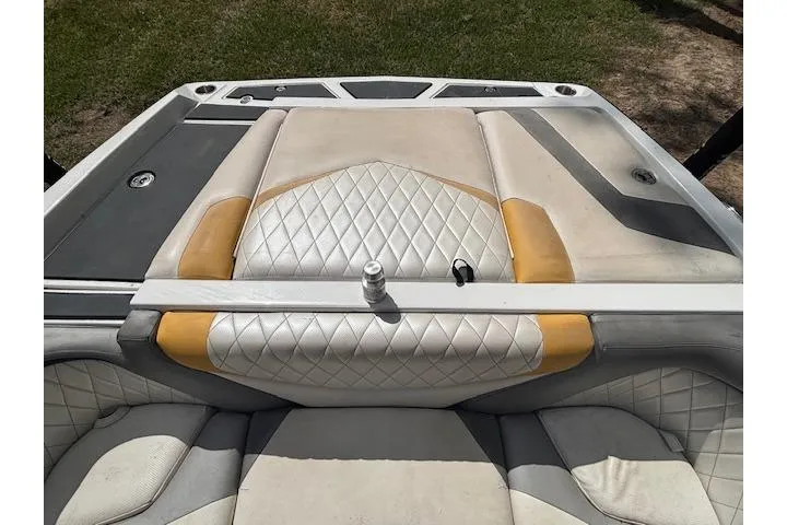 Slide: The Image of 2013 Tigé RZ4 boat interior with diamond-stitched upholstery and yellow accents. - 11
