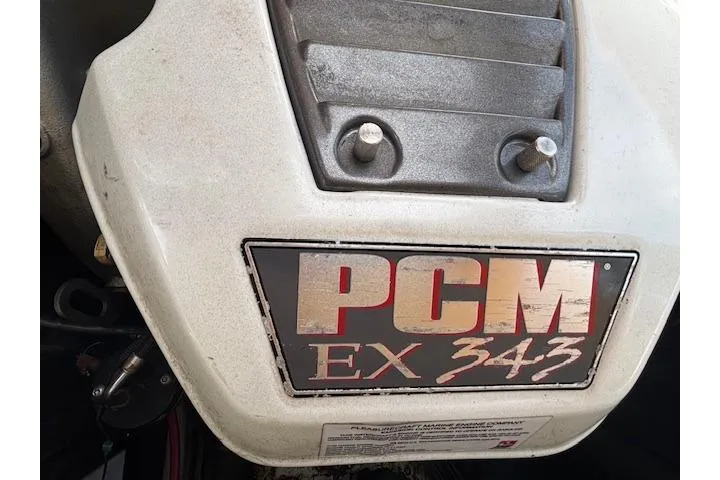 Slide: The Image of Engine cover of a 2013 Tigé RZ4 boat with PCM EX 343 branding. - 12