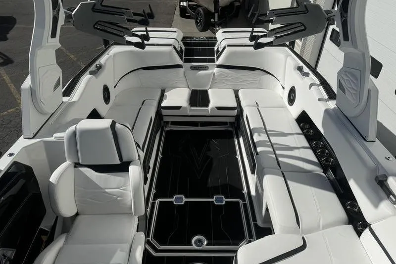 Slide: The Image of 2025 Supra SL 575 boat interior with luxurious white seating and sleek black accents. - 10