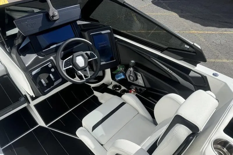 Slide: The Image of 2025 Supra SL 575 boat interior with modern dashboard and sleek white seating. - 12