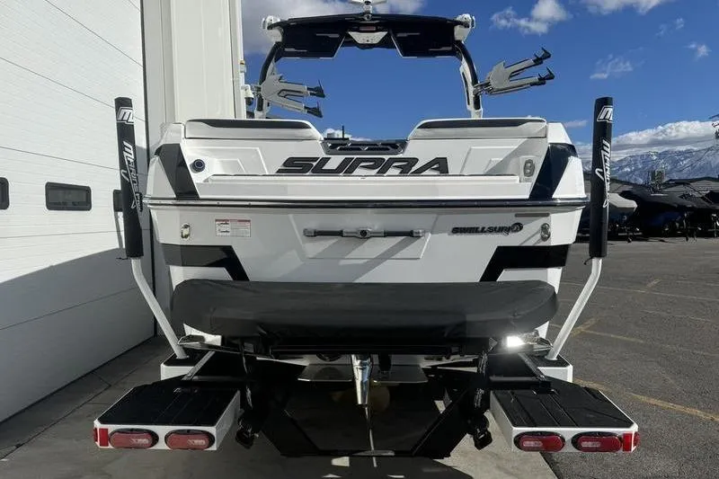 Slide: The Image of 2025 Supra SL 575 boat rear view, featuring sleek design and advanced wakeboarding features. - 2