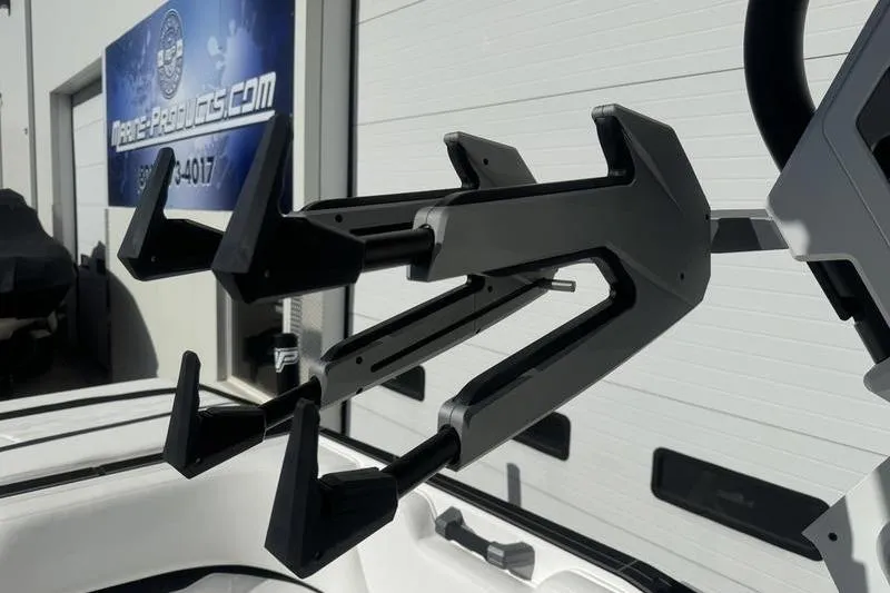 Slide: The Image of Wakeboard rack on a 2025 Supra SL 575 boat, mounted outdoors. - 6