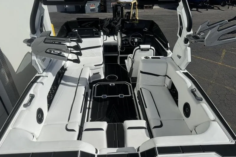 Slide: The Image of 2025 Supra SL 575 boat interior with sleek white seating and modern design. - 8